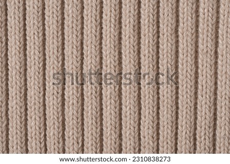 knitted pattern, beige woolen sweater texture background.