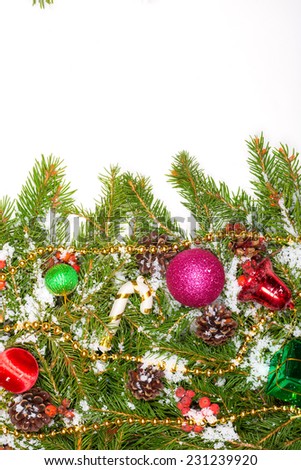 Christmas background with balls and decorations and snow, holly berry, cones isolated on white