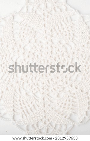 Off white crochet doily on a white background