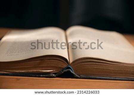 open book on the table black background