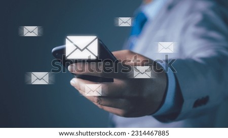 Businessman using smartphone with new email notification for business e-mail communication and digital marketing. Inbox receiving electronic message alert internet technology.