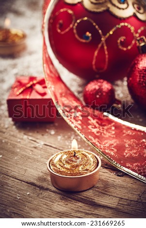 Christmas background with beautiful red balls, golden candles and snow
