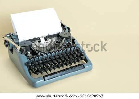 Vintage typewriter on beige background