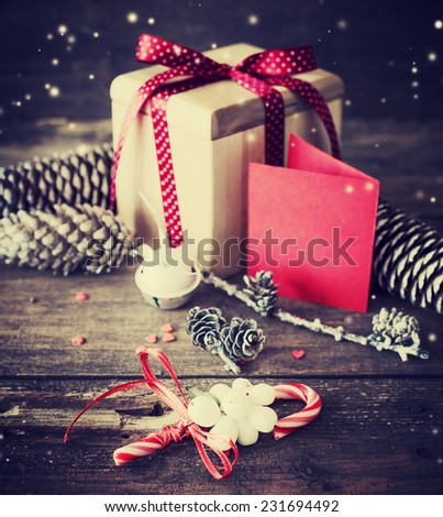 Christmas presents with red ribbon on dark wooden background in vintage style / Selective focus