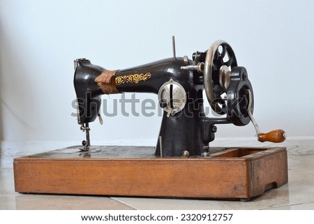 a large old metal sewing machine stands in the room