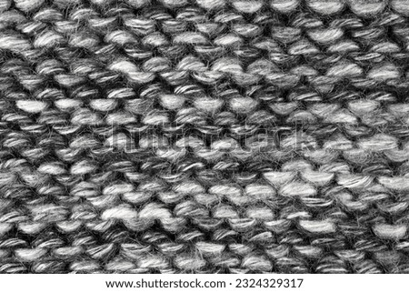 Grey, black, white color wool knitted background close up