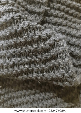 Black surface, knitted, yarn. Background design, photography. Textile, fabric template,  modern 