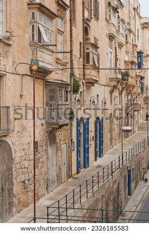 Valetta, Malta - June 6, 2023: Historic buildings lining narrow streets in the city of Valetta in Malta