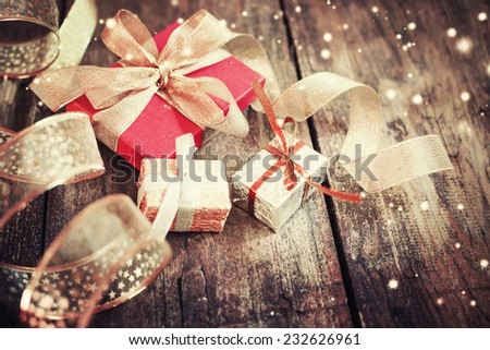 Christmas presents  on dark wooden background in vintage style / Selective focus