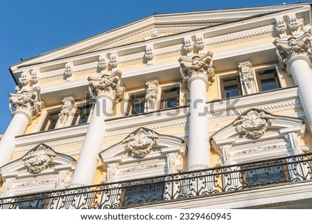 Decoration of stucco on the facade of an old building of the 19th century. The facade of a mansion built in the 19th century. Ancient architecture with stucco on the facade.