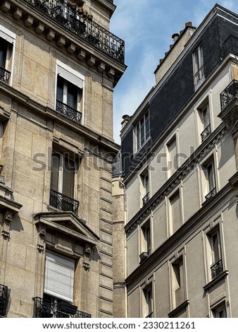 Facades of houses in Paris with balconies and shutters