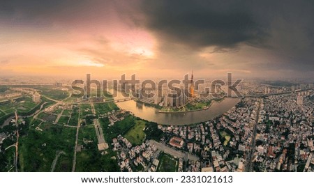 Aerial view of a Ho Chi Minh City, Vietnam with development buildings, transportation, energy power infrastructure. Financial and business centers. Sunset to night. Travel and landscape concept.