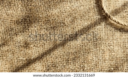 Burlap fabric, coarse jute weave and thick burlap rope. Background, texture, pattern, and frame.