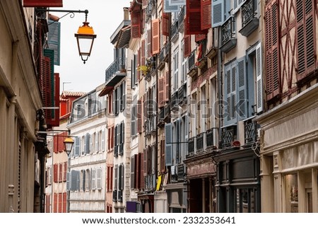 Main street of Bayonne with very picturesque architecture and colorful shuttered windows, France.