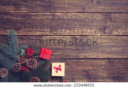 Gift boxes with pine branches on a wooden table.