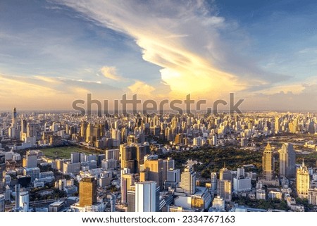 Aerial view of cityscape of Bangkok city, Thailand from roof top bar with sunset sky in lumpini area