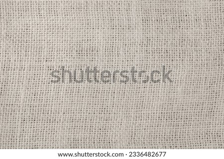 White burlap fabric as background, top view