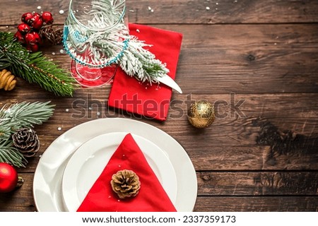 christmas holiday table setting on dark wood table