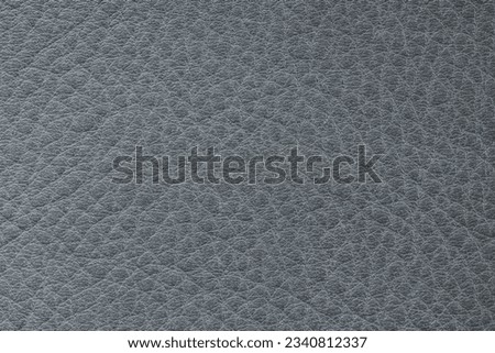 Genuine porous grainy leather texture closeup, grey color, matte surface, trendy background. Concept of shopping, manufacturing