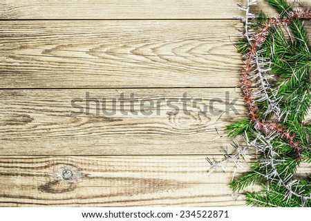 Fir branches on a wooden background