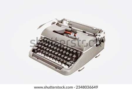 Metal typewriter reminiscent of bygone days with dark keys and an iconic lever. Photographed from above at a three-quarters angle, starkly offset by white