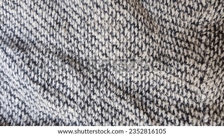 A photograph of a machine weaved fabric shows the fabric interlaced to form a fabric.