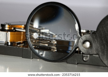 hard drive and magnifying glass, representing the process of searching data, technical view of saving data