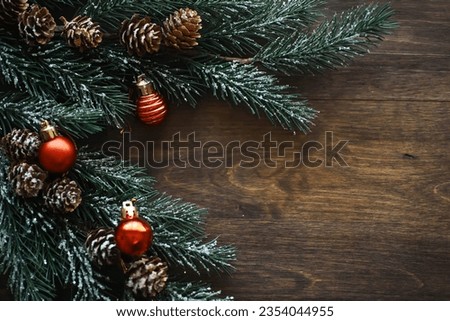 Christmas background with fir tree and decoration on dark wooden