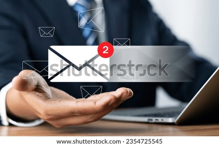 Email Marketing Concept. Businessman use mobile phone sending newsletters and engaging contacting clients or customers and networking online. Business communication and marketing networking online.