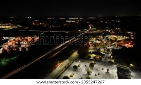 A long exposure shot of a busy highway in the night surrounded by city lights