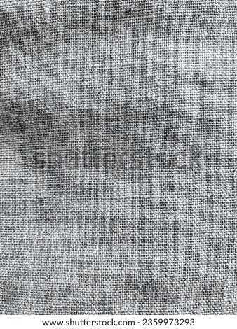 The texture of coarse untreated flax. Linen fabric background. Coarse woven fabric.