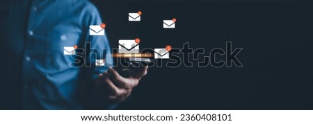Businessman hand pressing smartphone for sending the e-mail from the laptop computer, Email and SMS marketing concept. Scheme of direct sales in business. List of clients for mailing.