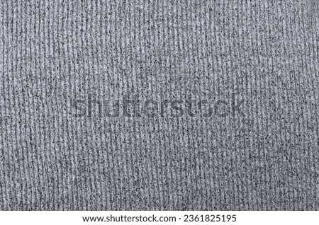 surface texture of the cotton fabric is thick and striped. gray fleece fabric detail. wavy or wrinkled sweater