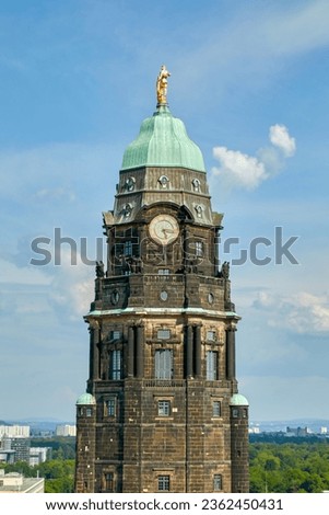 The well known town hall tower in Dresden, capital of Saxony, Germany with the golden figure of Hercules at the top, portrait format