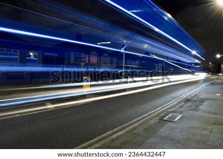 A long-exposure shot of a street illuminated with lights