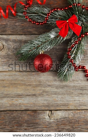Branch of Christmas tree with balls on grey wooden background