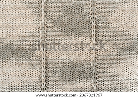 Sweater or scarf fabric texture large knitting. Knitted jersey background with a relief pattern. Wool hand- machine, handmade