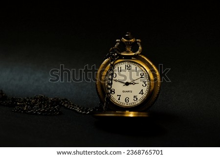 Close up shot of a classic pocket watch. Very minimal and vintage.
