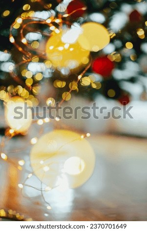 Christmas wallpaper. New Year and Christmas decor. red balls and shining garland.Holiday garlands bokeh background.