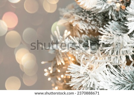 Christmas tree branches with decorations, balls, garlands, bokeh. Postcard with space for text.	