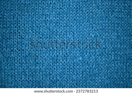 wool turquoise knitted sweater texture close-up, ocean knitted front surface, blue telpai background, concept, hand-knitted banner, warm winter facial knitted texture