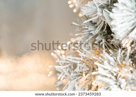 Christmas tree branches with garlands, bokeh. Postcard with copy space. Xmas winter blurred background. Holiday background, border. New year winter art design