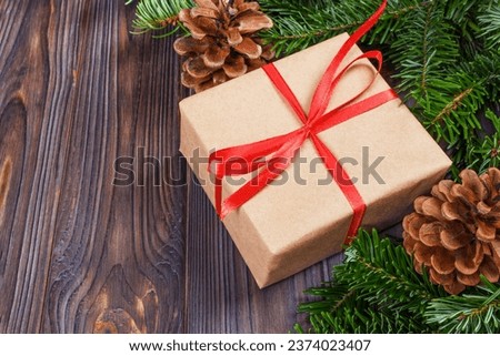 Christmas presents in decorative boxes, white wood background.