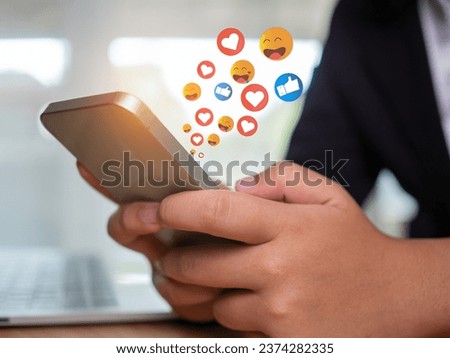 Social media and technology concepts , Human hand is holding a phone and there is a social media icon.