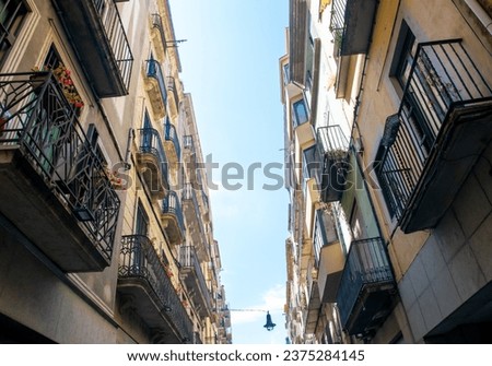 Empty street with beautiful historic houses, windows, stone road in the center of old town. Spain.