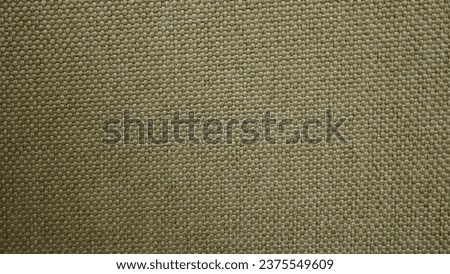 A close-up of a beige fabric with a checkered pattern. The fabric is soft and textured, and it looks like it would be perfect for a variety of purposes, such as curtains, upholstery, or even clothing.