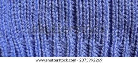 Pattern fabric made of wool. Handmade knitted fabric blue wool background texture