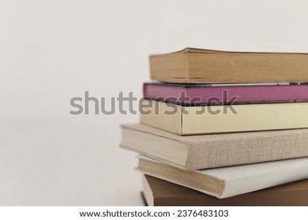 Stack of books on white education school