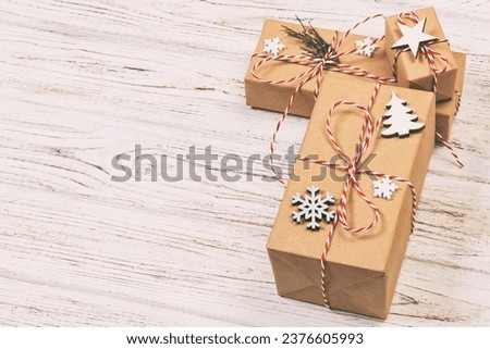 Christmas gift box with copy space. Xmas present boxwith decoration on wooden background. Toned.
