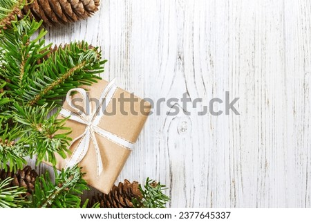 Christmas background with Christmas gift on wooden background with Fir branches. Xmas and Happy New Year composition. top view.